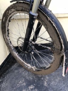 Frontwheel of an HNF Adventure covered with mud